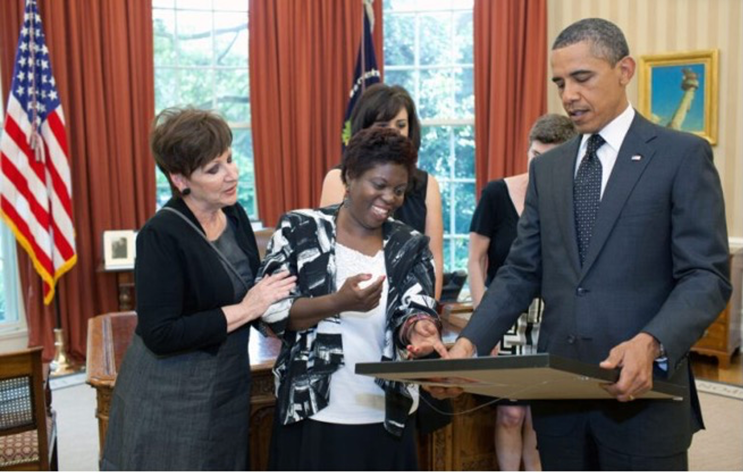 President Barack Obama looks at a painting by Lois Curtis during a meeting in the Oval Office. June 20, 2011. (Official White House Photo by Pete Souza)